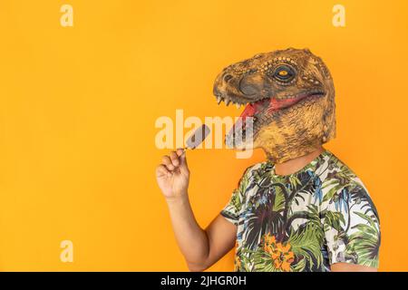 Male in dinosaur animal mask holding chocolate ice cream Stock Photo