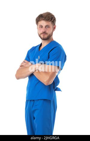 Healthcare, profession and medicine - doctor or male nurse in blue uniform with crossed arms isolated on white background Stock Photo