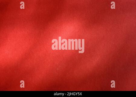 Empty red textured wall close up with shadows. Sparse texture and background Stock Photo