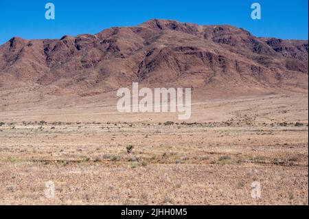 Panoramic view of desert plains in Namibia Africa with hills and mountains in the background Stock Photo