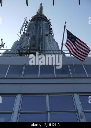 The Spire of the Empire State Building with US Flag, as viewed from the 86th Floor Observation Deck, June 2012 Stock Photo