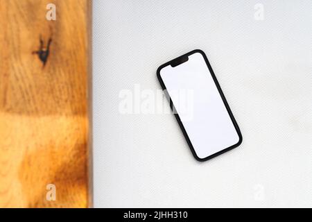 Smartphone with mockup white screen on modern sofa arm, top view copy space image Stock Photo