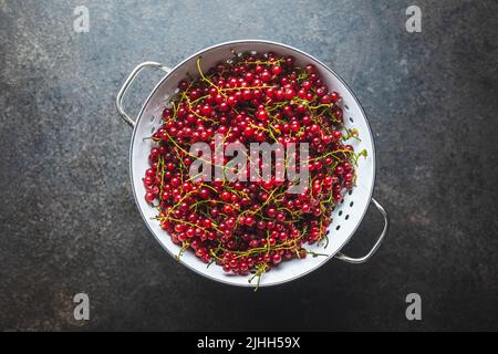 Ripe red currant in a colander. Top view. Stock Photo