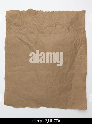 brown baking paper sheet isolated on white background, top view, parchment for baking culinary Stock Photo