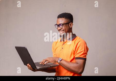 excited boy isolated over white using his laptop Stock Photo