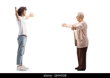 Happy young man meeting an elderly woman with arms wide open isolated on white background Stock Photo