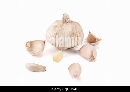 Fresh garlic clove and bulb isolated on bright background. Stock Photo