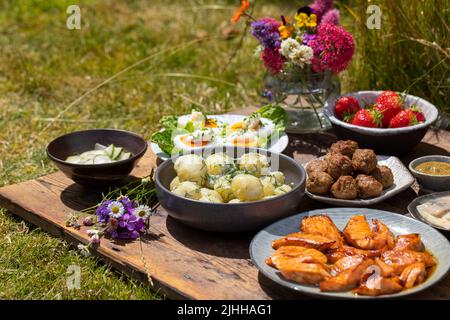 Scandinavian midsummer meal with  potato salad, salmon and eggs Stock Photo