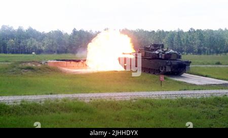 An M1A2 Abrams tank crew assigned to the 'Mustang Squadron,' 6th Squadron, 8th Cavalry Regiment, 2nd Armored Brigade Combat Team, 3rd Infantry Division, fires the modernized M1A2 SEPv3 Abrams tank during the squadron's family day on Fort Stewart, Georgia, July 17, 2022. Family days give the unit and the garrison the opportunity to form and nurture relationships with Soldiers' families and the local community, building lasting connections and bonds that demonstrate the Army's commitment to family and the community. (U.S. Army photo by Staff Sgt. Justin McClarran)