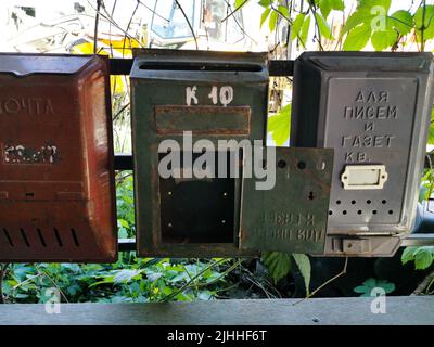 Old metal mailboxes. The inscription on the boxes in Russian from left to right Mail, apt. 10, For letters and newspapers, apt., Correspondence is del Stock Photo