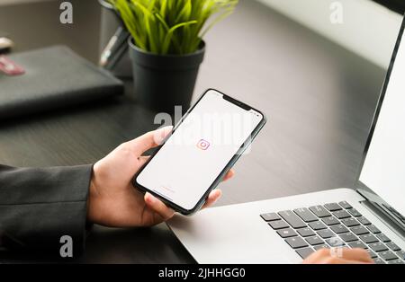 CHIANG MAI, THAILAND - April 06, 2021 : A woman hand holding iphone with login screen of instagram application. Instagram is largest and most popular Stock Photo