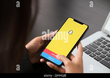 CHIANG MAI ,THAILAND April 06 2021 : woman holding a iphone with social network service Snapchat on the screen Stock Photo