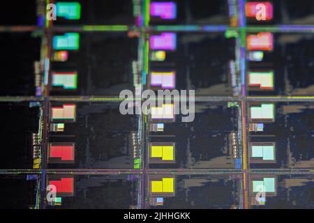 Silicon wafer with microchips used in electronics for the fabrication of integrated circuits. Full-frame high-tech macro background. Stock Photo