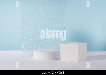 Acrylic plate, podium, background for cosmetic product packaging on blue backdrop with stylish props. Showcase for jewellery presentation, display for Stock Photo