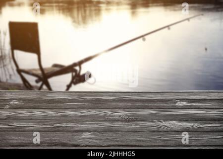 Camping chair with fishing rod at riverside on sunny dayの素材  [FY310206085742]