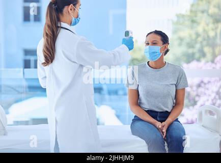 Physician using thermometer to measure temperature of aged patient ...