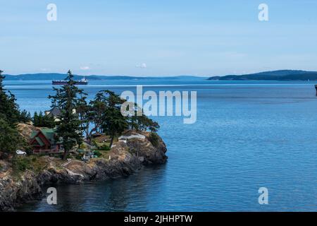 Bulk carrier passing through Swanson Channel, North Pender Island, British Columbia, Canada Stock Photo