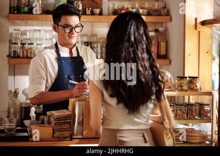 Smiling barista taking order from customer he is in love with Stock Photo