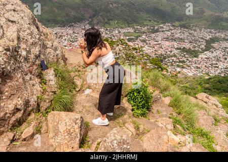 Latin teenager recording a video for social networks outdoors Stock Photo