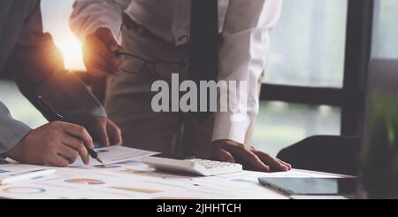 Administration or Accountant discussing with partner are meeting to audit finance planning sales to meet targets set in next year. Finance concept. Stock Photo