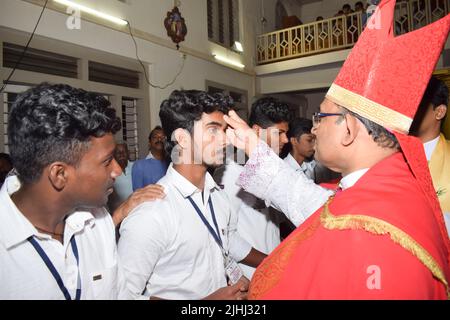 Catholic bishop is giving Confirmation sacrament Stock Photo - Alamy