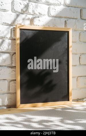Photo frames on floor over white brick wall Stock Photo
