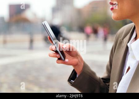 hand of an unrecognizable woman using a mobile Stock Photo
