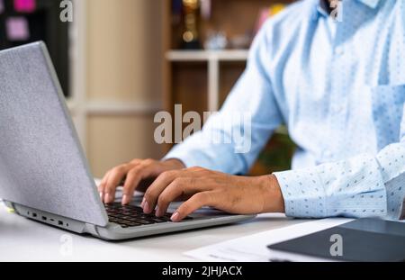close up shot of corporate employee hands working on laptop while sitting at office - concept of technology, hard working and career. Stock Photo