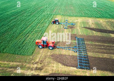 High angle shot of harvesters working in the field Stock Photo