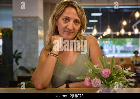 a girl drinks for an hour in a cafe Stock Photo