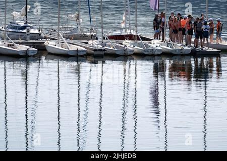 Waldeck, Germany. 19th July, 2022. A group stands on a jetty next to sailboats in Lake Edersee in northern Hesse. The third largest reservoir in Germany is 46 percent full. Credit: Swen Pförtner/dpa/Alamy Live News Stock Photo