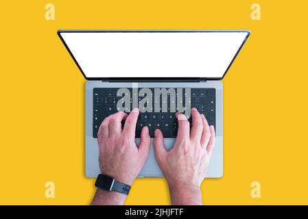 above view of person using modern laptop computer with copy space on screen against orange background Stock Photo