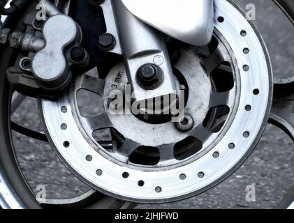 Wear brake disc on the front wheel of motorcycle Stock Photo