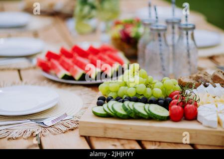 Dining table set for dinner on the terrace in summer, garden party concept. Stock Photo