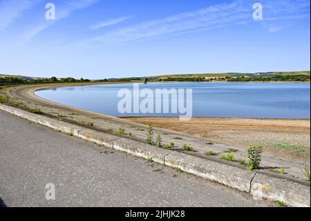 Lewes UK 19th July 2022 - The water levels at Arlington Reservoir near Lewes in East Sussex are 71% full during the current heatwave weather today with temperatures forecast to go above 40 degrees in some parts of the UK.  An extreme red weather warning has been issued for today throughout parts of Britain : Credit Simon Dack / Alamy Live News Stock Photo
