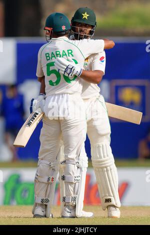 Galle, Sri Lanka. 19th July 2022. Pakistan's Abdullah Shafique celebrates with team mate Babar Azam after scoring a century during the 4th day of the 1st test cricket match between Sri Lanka vs Pakistan at the Galle International Cricket Stadium in Galle on 19th July, 2022. Viraj Kothalwala/Alamy Live News Stock Photo