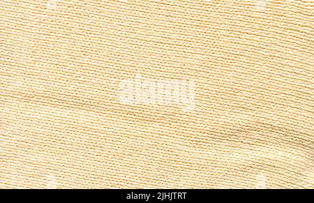 Abstract beige soft knitted pattern textured. Beige  knitted boho fabric texture with blank space for ads. Stock Photo
