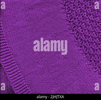 Background from softness lilac blanket. Warm magneta colored knitted wool background. Stock Photo