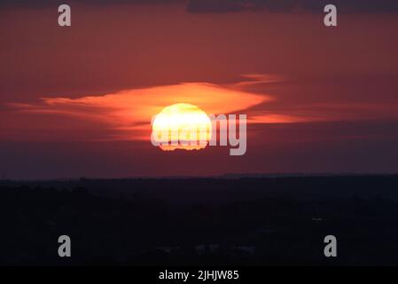 The sun setting over Surrey and Hampshire on one of the longest days of summer Stock Photo