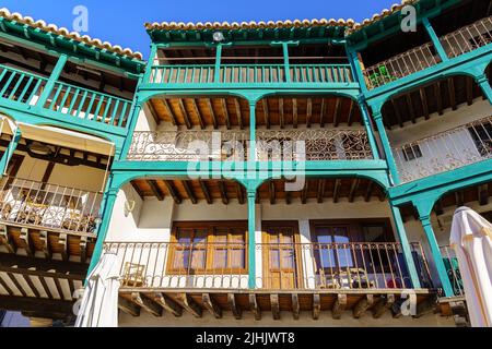 Typical balconies in the central square of Chinchon in Madrid, old wooden balconies in all the houses. Spain. Stock Photo