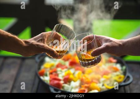 Two men drinking whiskey at the party at home Stock Photo