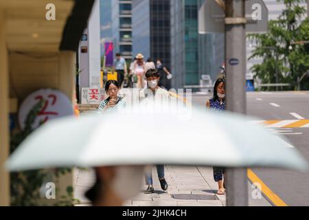 Seoul, South Korea. 19th July, 2022. People walk on a street in Seoul, South Korea, July 19, 2022. Credit: Wang Yiliang/Xinhua/Alamy Live News Stock Photo