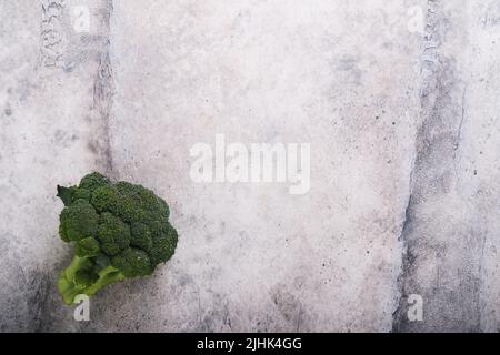 Broccolini. Fresh bunch of broccoli sprouts on concrete gray table or background. Healthy food concept. Food crisis concept. Food cooking background. Stock Photo