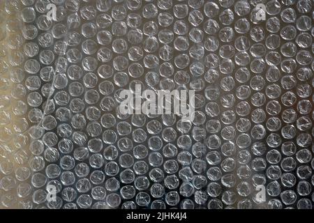 Air bubble wrap close-up. Bubble wrap texture. Texture background packaging material. The film protects the surface from impact. Polyethylene. Stock Photo