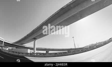Road Highway Intersection Ramp entry exit flyover ramp in abstract urban black white photo. Stock Photo