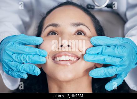 A smile that sparkles. a dentist checking their handiwork after a procedure. Stock Photo