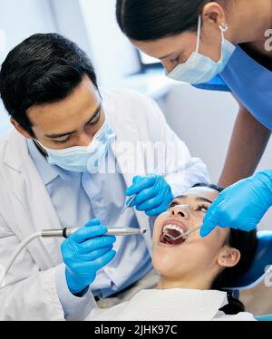 Dedicated to human health. a dentist working on his young patient. Stock Photo