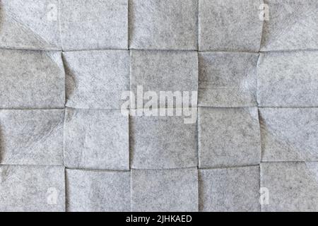 Abstract gray felt background. Home storage basket made of soft grey felt material. Surface of felted wool fabric texture. Close-up, square pattern Stock Photo