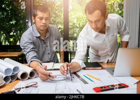 Engineer or architect meeting for project working with partner and using divider compass tools on blueprint in office on site. Stock Photo