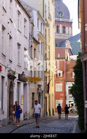 Riga Latvia; Cobbled street scene in the narrow streets of Riga Old Town, with Riga Cathedral, Riga, Latvia Baltic States Europe Stock Photo